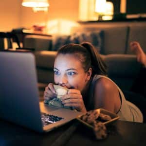 Woman watching a movie in a laptop